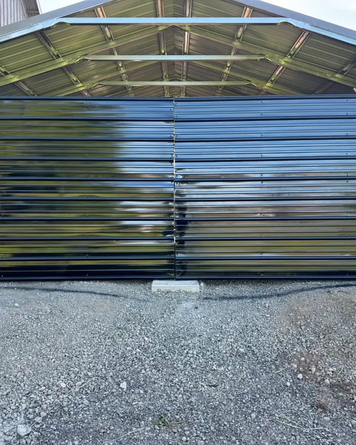 Glossy black metal double swing gate closing steel carport bay — Interstate Gate Repair